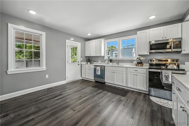 21405 Chesterfield Ave, Chesterfield, VA 23803 - kitchen with appliances with stainless steel finishes, light countertops, white cabinets, dark wood-type flooring, and recessed lighting