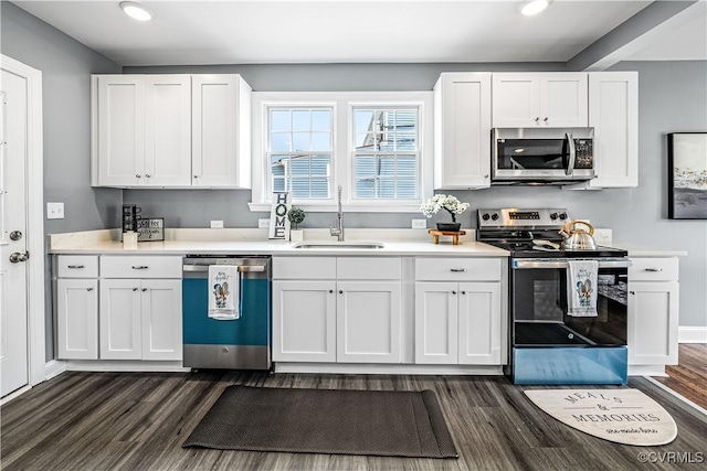 21405 Chesterfield Ave, Chesterfield, VA 23803 - kitchen with appliances with stainless steel finishes, dark wood-type flooring, recessed lighting, white cabinetry, and light countertops