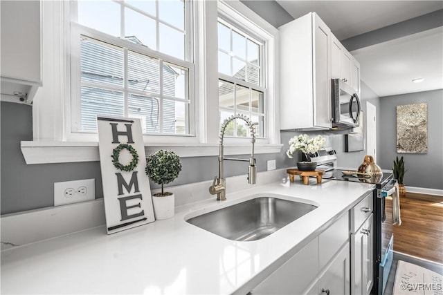 21405 Chesterfield Ave, Chesterfield, VA 23803 - kitchen with stainless steel appliances, light countertops, and white cabinetry