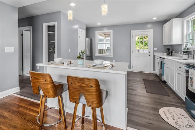 21405 Chesterfield Ave, Chesterfield, VA 23803 - kitchen featuring a kitchen bar, white cabinetry, plenty of natural light, and recessed lighting