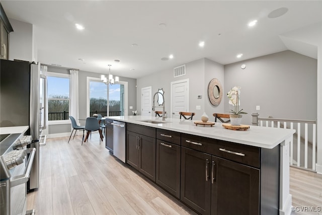 13213 Garland Ln, Midlothian, VA 23114 - kitchen with light countertops, light wood-style floors, stainless steel dishwasher, a chandelier, and range
