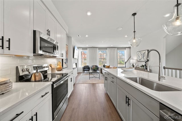 13213 Garland Ln, Midlothian, VA 23114 - kitchen featuring appliances with stainless steel finishes, open floor plan, dark wood-type flooring, recessed lighting, and backsplash