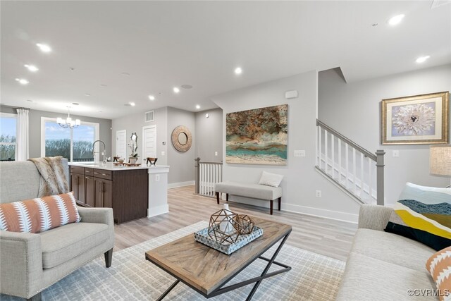 13213 Garland Ln, Midlothian, VA 23114 - living room featuring a chandelier, recessed lighting, light wood-type flooring, and stairway