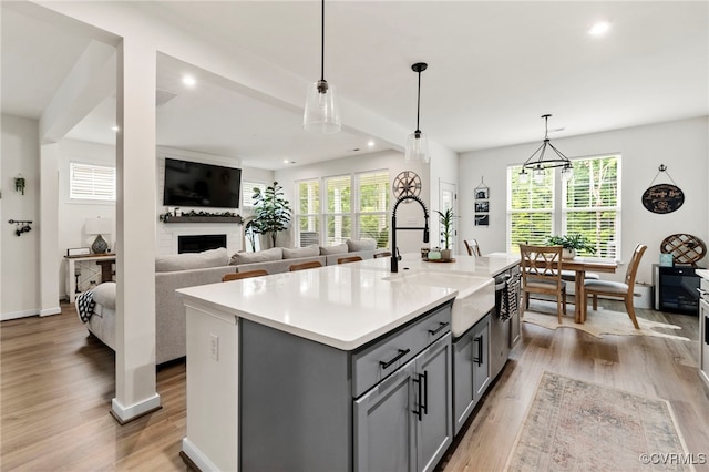 18517 Palisades Rdg, Moseley, VA 23120 - kitchen featuring gray cabinetry, light wood-style floors, recessed lighting, a large fireplace, and light countertops