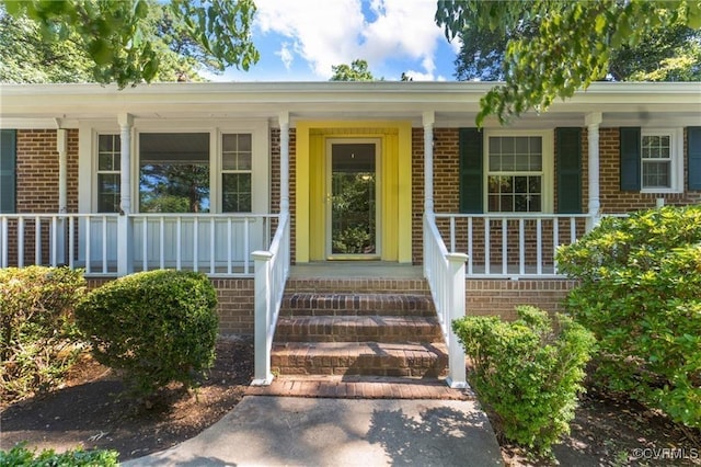 10212 Sauna Dr, North Chesterfield, VA 23236 - view of exterior entry featuring covered porch and brick siding