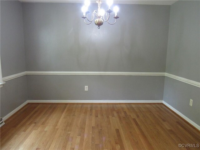 10212 Sauna Dr, North Chesterfield, VA 23236 - unfurnished room with light wood finished floors and a chandelier