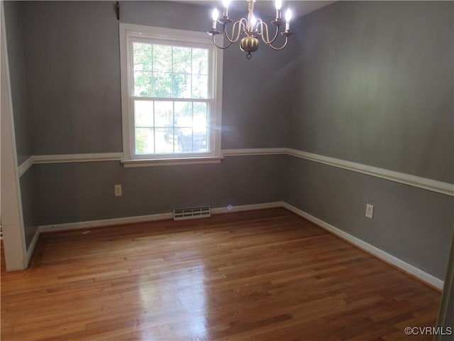10212 Sauna Dr, North Chesterfield, VA 23236 - empty room with a chandelier, plenty of natural light, and wood finished floors