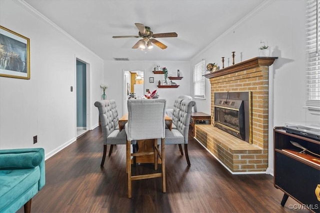 5205 Jerral Dr, Prince George, VA 23875 - dining area featuring ceiling fan, dark wood finished floors, a brick fireplace, and crown molding