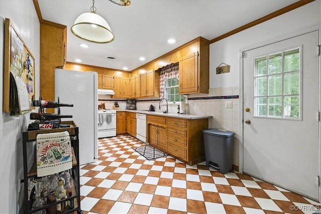5205 Jerral Dr, Prince George, VA 23875 - kitchen featuring white appliances, light countertops, under cabinet range hood, brown cabinetry, and ornamental molding
