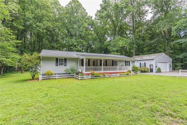 9118 Epps Rd, Mechanicsville, VA 23111 - ranch-style home with an outbuilding, covered porch, a front lawn, a detached garage, and view of wooded area