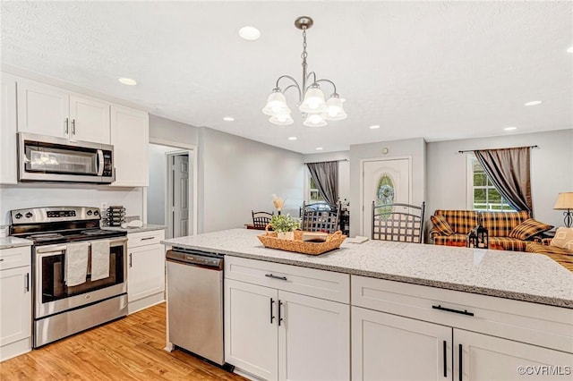 9118 Epps Rd, Mechanicsville, VA 23111 - kitchen with appliances with stainless steel finishes, a chandelier, white cabinetry, light wood finished floors, and recessed lighting