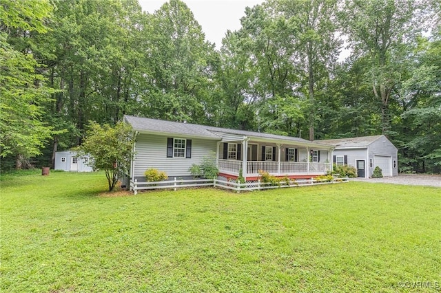 9118 Epps Rd, Mechanicsville, VA 23111 - ranch-style house with a porch, an outbuilding, a front lawn, a garage, and view of scattered trees