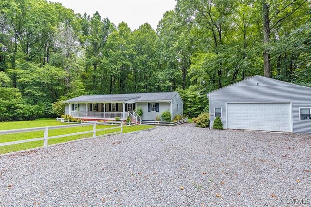 9118 Epps Rd, Mechanicsville, VA 23111 - single story home with a porch, a detached garage, a forest view, and an outbuilding