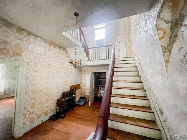 22446 E Depot St, Newsoms, VA 23874 - stairs featuring wallpapered walls, wood finished floors, and a chandelier