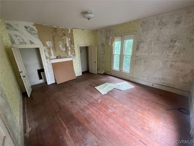22446 E Depot St, Newsoms, VA 23874 - unfurnished living room featuring wood-type flooring and wallpapered walls