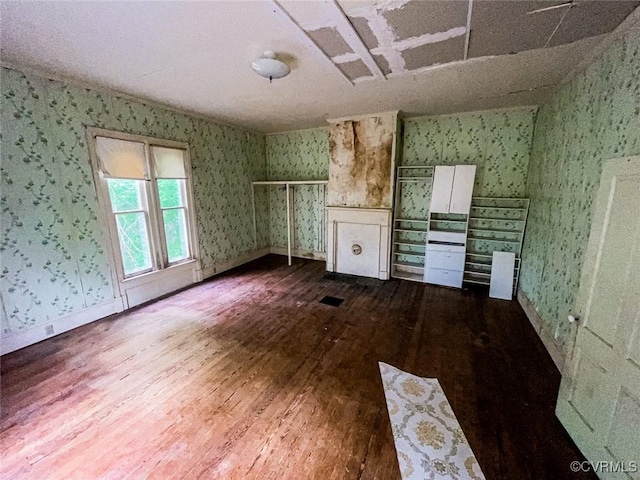 22446 E Depot St, Newsoms, VA 23874 - unfurnished living room featuring wallpapered walls and wood finished floors