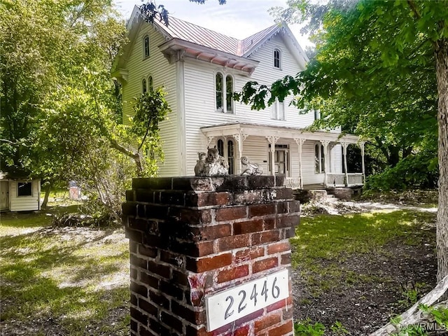 22446 E Depot St, Newsoms, VA 23874 - victorian house with a porch and a metal roof