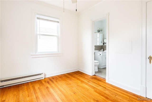 2711 Maplewood Rd, Henrico, VA 23228 - unfurnished bedroom with a baseboard heating unit, light wood finished floors, connected bathroom, and crown molding