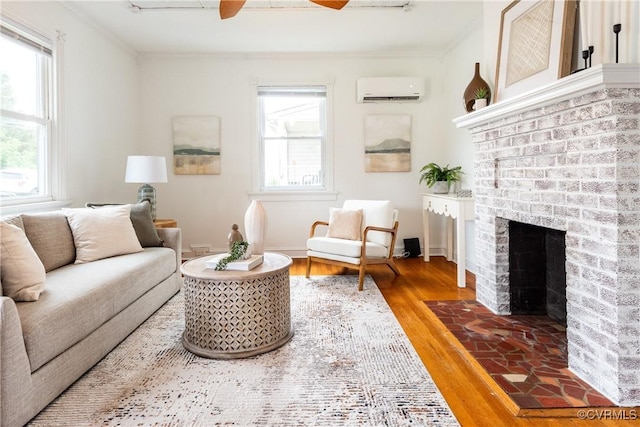 2711 Maplewood Rd, Henrico, VA 23228 - living area featuring a wall unit AC, crown molding, ceiling fan, a brick fireplace, and wood finished floors