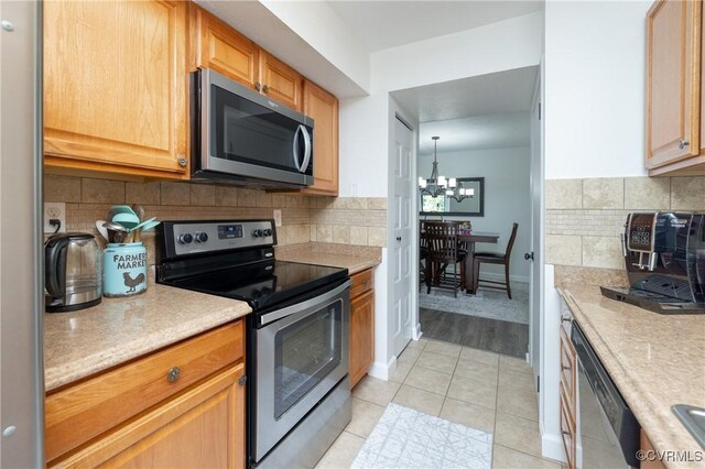 1501 Largo Rd Unit 302, Henrico, VA 23238 - kitchen with appliances with stainless steel finishes, light countertops, and a chandelier