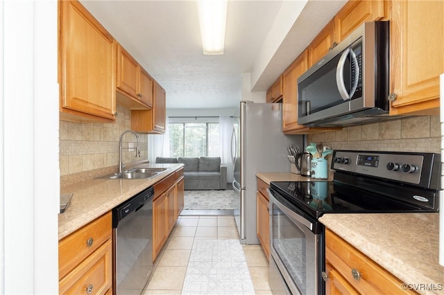 1501 Largo Rd Unit 302, Henrico, VA 23238 - kitchen with stainless steel appliances, light countertops, backsplash, and light tile patterned floors