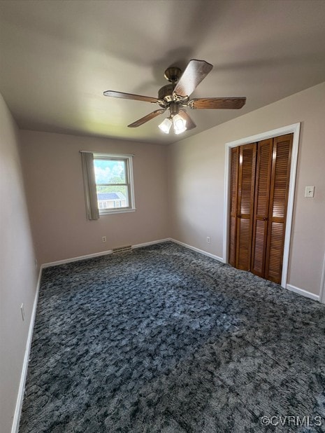 unfurnished bedroom with carpet, a ceiling fan, and a closet
