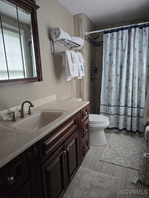 10818 Sebring Dr, Henrico, VA 23233 - bathroom featuring vanity, a shower with shower curtain, and wood finished floors