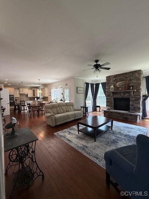 17037 Windon Ct, Moseley, VA 23120 - living room with a stone fireplace, a ceiling fan, dark wood-style floors, and crown molding