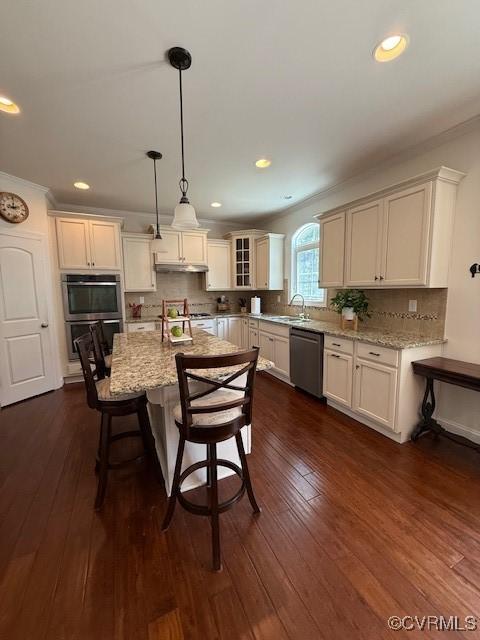 17037 Windon Ct, Moseley, VA 23120 - kitchen featuring stainless steel appliances, light stone counters, tasteful backsplash, a kitchen bar, and ornamental molding