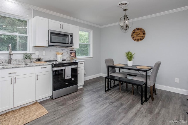 9300 Greatbridge Rd, Chesterfield, VA 23237 - kitchen with appliances with stainless steel finishes, dark wood-style floors, white cabinetry, decorative backsplash, and light stone countertops