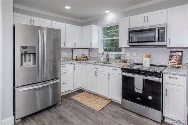 9300 Greatbridge Rd, Chesterfield, VA 23237 - kitchen featuring appliances with stainless steel finishes, ornamental molding, white cabinets, wood finished floors, and backsplash