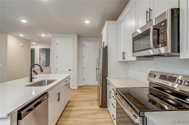7082 Braxton Ct, Ladysmith, VA 22546 - kitchen featuring stainless steel appliances, light wood finished floors, white cabinetry, light countertops, and recessed lighting
