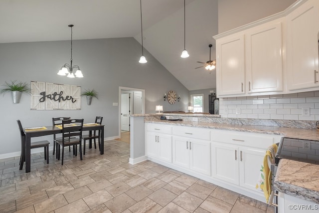 8622 Rock Cedar Rd, New Kent, VA 23124 - kitchen featuring white cabinetry, high vaulted ceiling, a peninsula, a chandelier, and tasteful backsplash