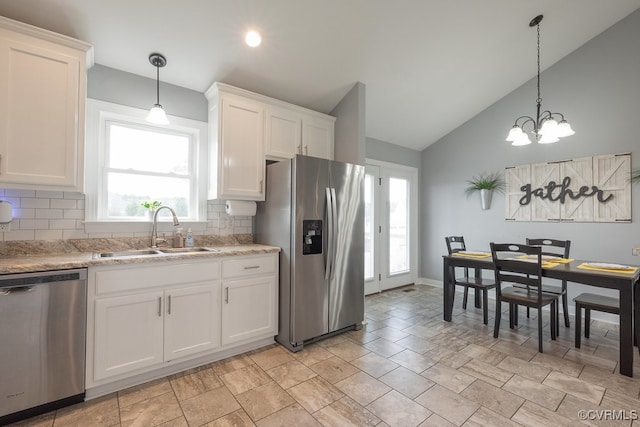 8622 Rock Cedar Rd, New Kent, VA 23124 - kitchen with appliances with stainless steel finishes, tasteful backsplash, vaulted ceiling, white cabinetry, and light countertops