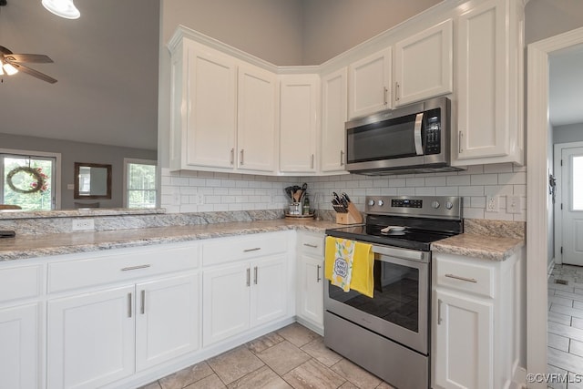 8622 Rock Cedar Rd, New Kent, VA 23124 - kitchen with appliances with stainless steel finishes, white cabinetry, a ceiling fan, and tasteful backsplash