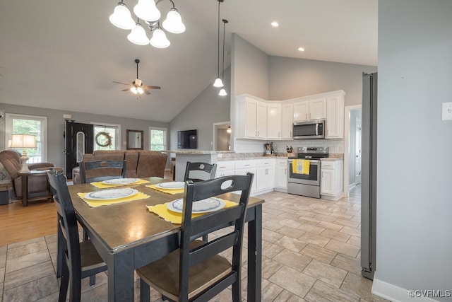 8622 Rock Cedar Rd, New Kent, VA 23124 - dining space featuring high vaulted ceiling, a chandelier, plenty of natural light, a ceiling fan, and recessed lighting