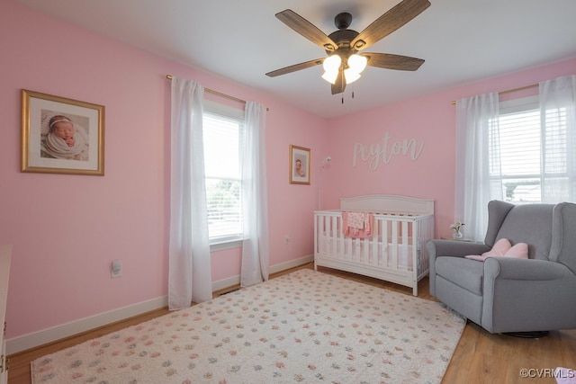 8622 Rock Cedar Rd, New Kent, VA 23124 - bedroom with wood finished floors, a crib, and a ceiling fan