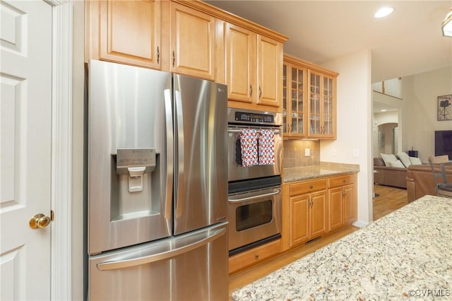 4837 Glenmorgan Ct, Chester, VA 23831 - kitchen featuring stainless steel appliances, light wood-style flooring, backsplash, light stone counters, and glass insert cabinets