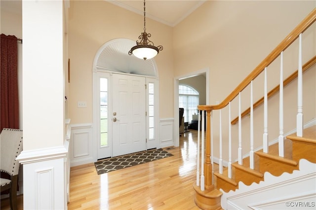 4837 Glenmorgan Ct, Chester, VA 23831 - entrance foyer featuring light wood-type flooring, ornamental molding, a decorative wall, stairway, and wainscoting