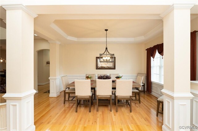 4837 Glenmorgan Ct, Chester, VA 23831 - dining area featuring a tray ceiling, light wood-style floors, a wainscoted wall, a decorative wall, and arched walkways
