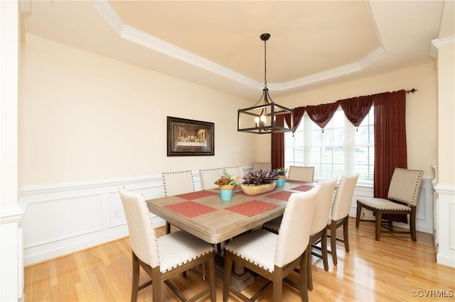 4837 Glenmorgan Ct, Chester, VA 23831 - dining area with a tray ceiling, light wood-style flooring, a wainscoted wall, a chandelier, and a decorative wall