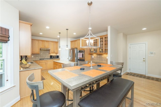 4837 Glenmorgan Ct, Chester, VA 23831 - kitchen featuring light brown cabinets, appliances with stainless steel finishes, backsplash, light wood-type flooring, and a kitchen island