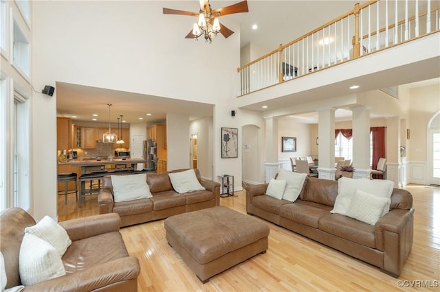 4837 Glenmorgan Ct, Chester, VA 23831 - living area with light wood-style flooring, a towering ceiling, ceiling fan, recessed lighting, and ornate columns