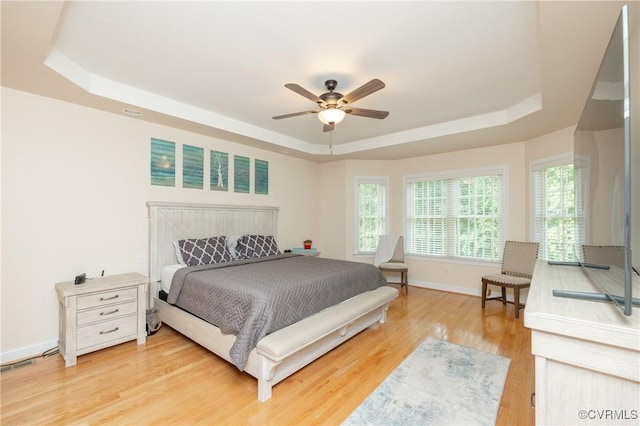 4837 Glenmorgan Ct, Chester, VA 23831 - bedroom featuring a tray ceiling, light wood-style floors, and ceiling fan