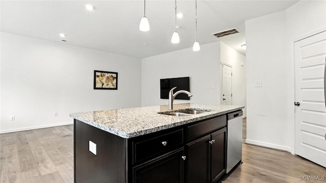 7750 Leeds Castle Ln, New Kent, VA 23124 - kitchen featuring dishwasher, light wood-type flooring, light stone countertops, a center island with sink, and hanging light fixtures