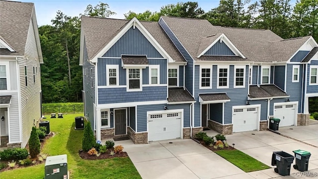 7750 Leeds Castle Ln, New Kent, VA 23124 - craftsman-style house featuring board and batten siding, stone siding, driveway, a garage, and a shingled roof