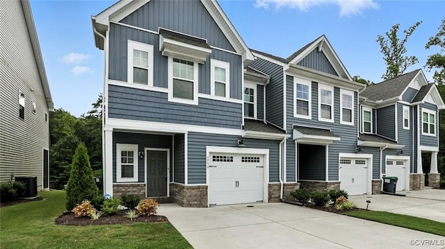 7750 Leeds Castle Ln, New Kent, VA 23124 - craftsman-style home with board and batten siding, a garage, concrete driveway, and stone siding