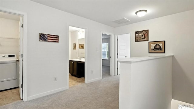 7750 Leeds Castle Ln, New Kent, VA 23124 - hallway with washer / dryer and light carpet
