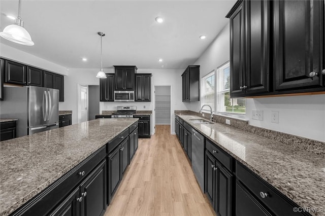 10485 Eagle Ct, Prince George, VA 23860 - kitchen with appliances with stainless steel finishes, dark cabinetry, light wood-style flooring, dark stone counters, and recessed lighting