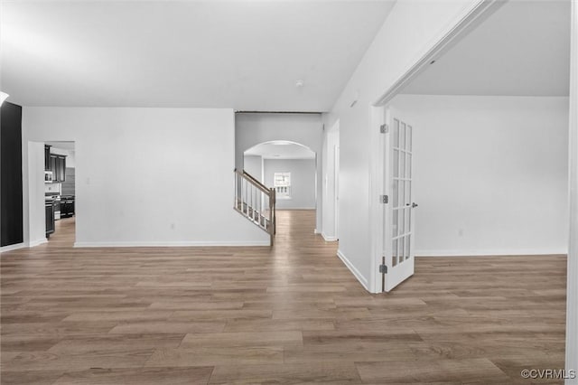 10485 Eagle Ct, Prince George, VA 23860 - unfurnished room with arched walkways, stairway, and wood finished floors
